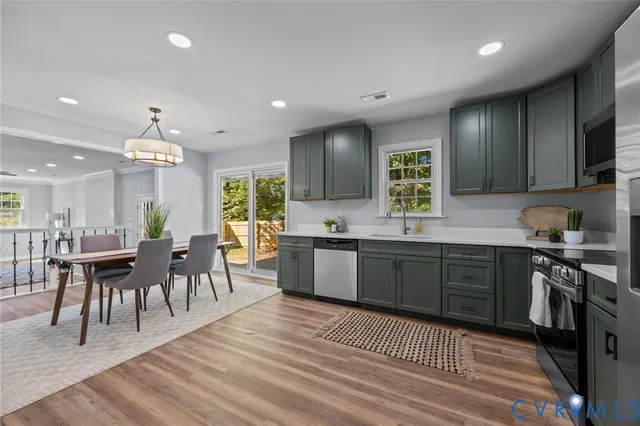 a bath room with a sink a toilet and a window