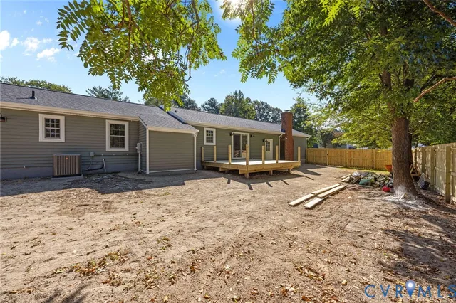 a view of a yard with plants and trees