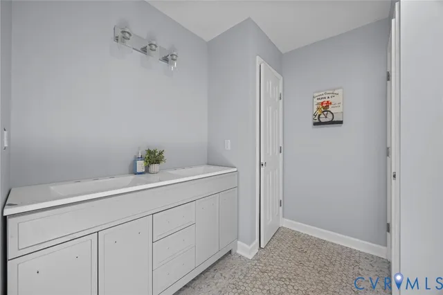 a bedroom with a bed and painting on the wall