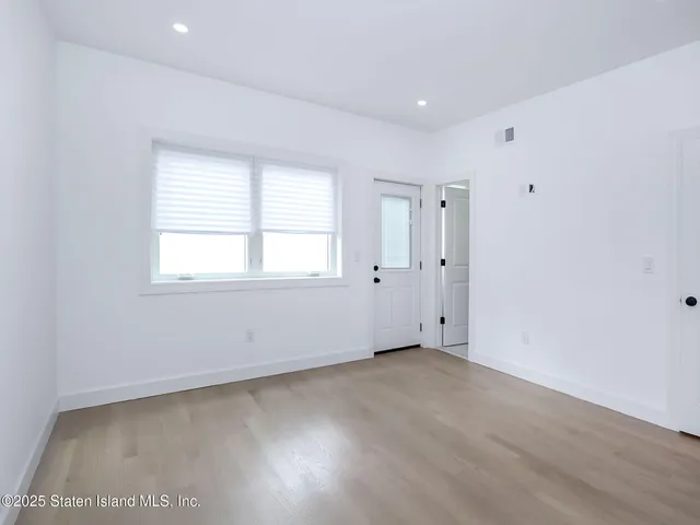 a bedroom with a bed and a potted plant