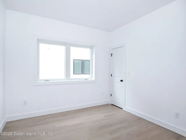a large white kitchen with white cabinets