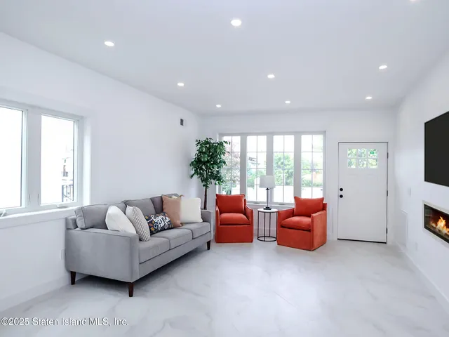 a kitchen with stainless steel appliances a refrigerator a stove a sink a dining table and chairs