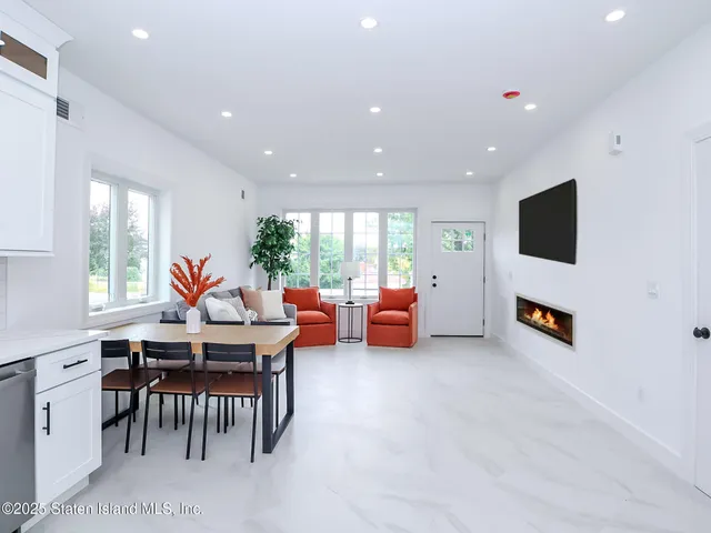 a kitchen with stainless steel appliances granite countertop a sink a stove and white cabinets