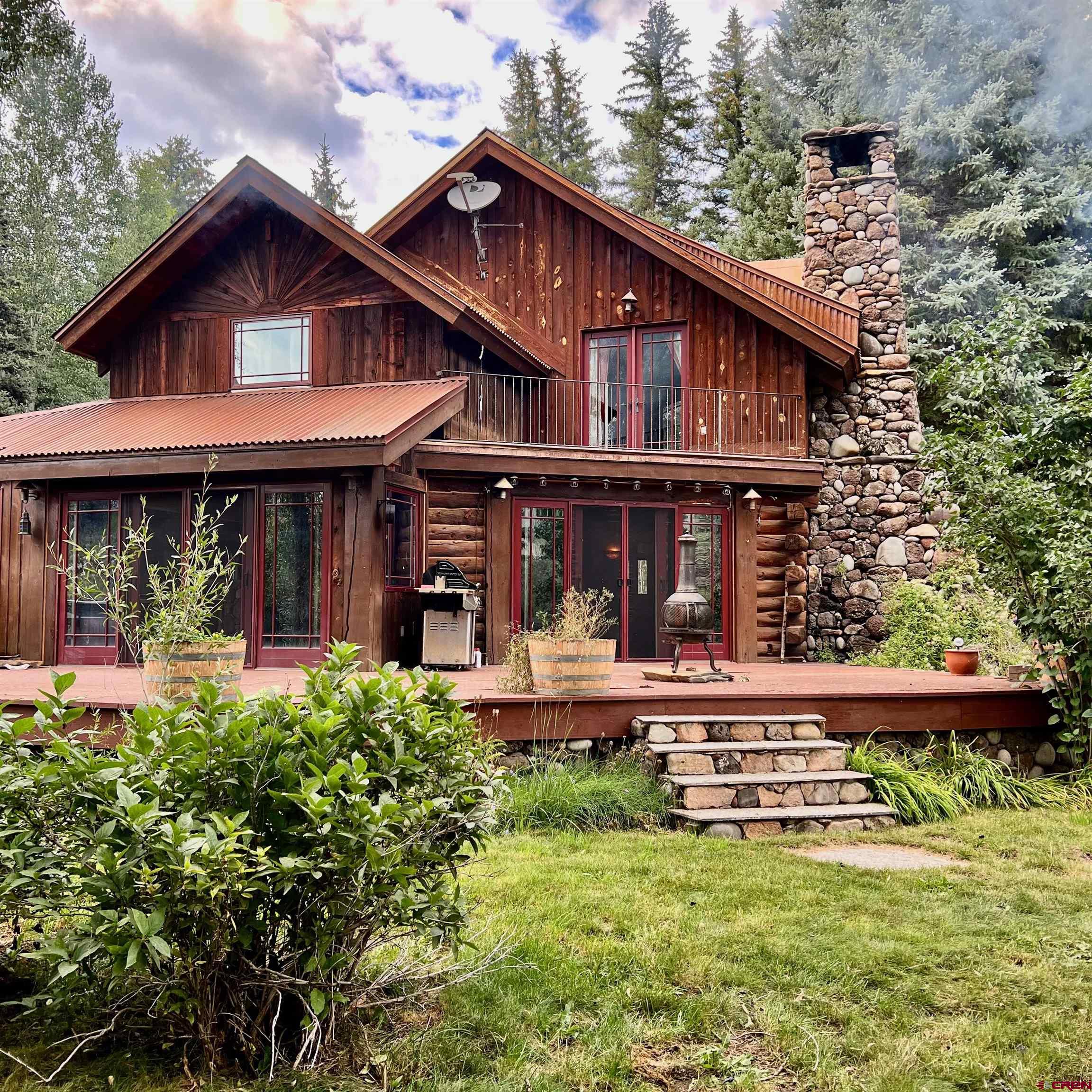 a view of a house with a yard and sitting area