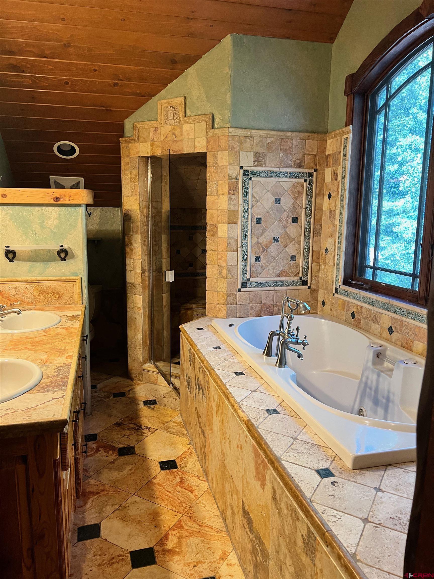 202 Lower Allen Road Crested Butte, CO 81224 - Photo 14 of 21 a bathroom with a bathtub and a shower
