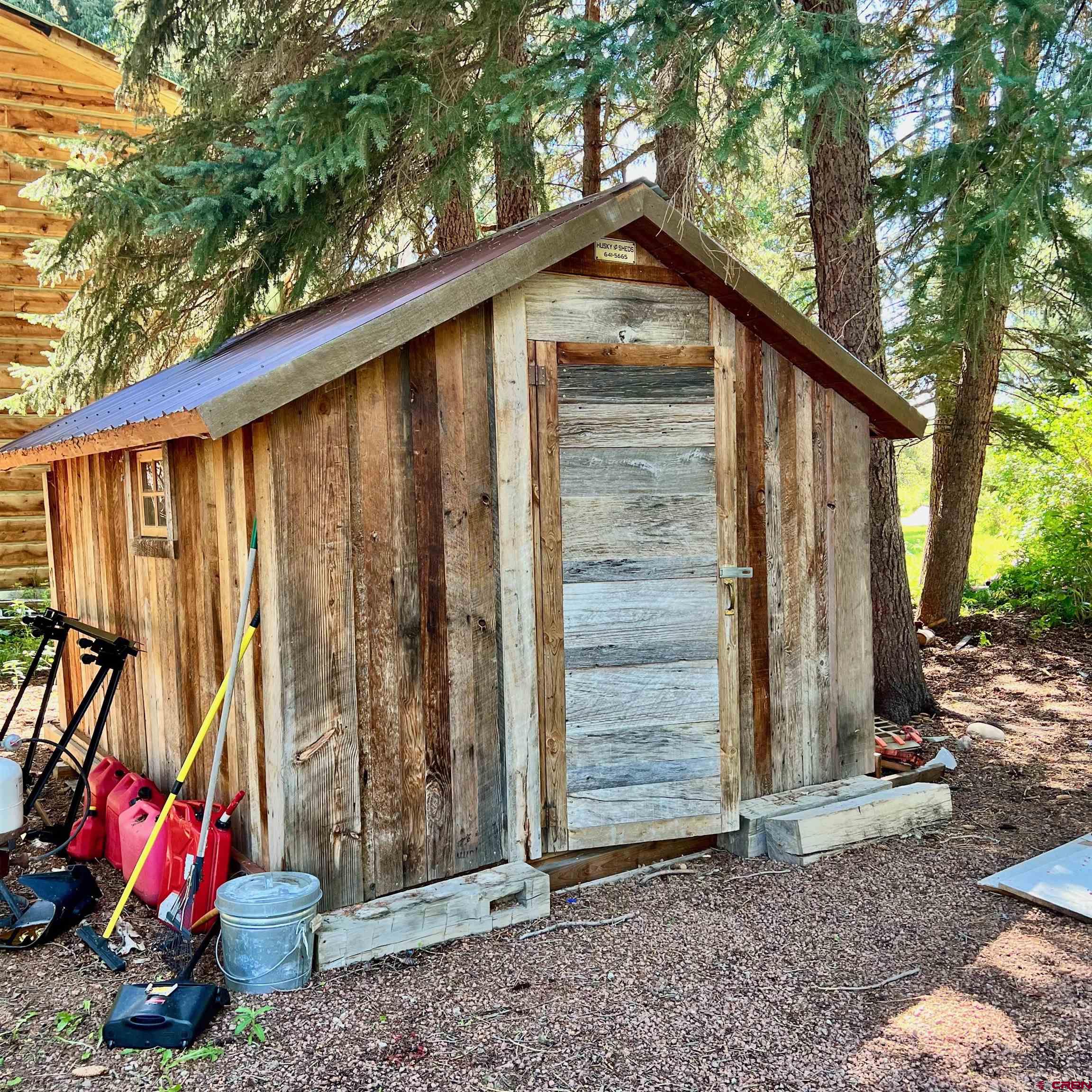202 Lower Allen Road Crested Butte, CO 81224 - Photo 16 of 21 a backyard of a house with seating space and trees