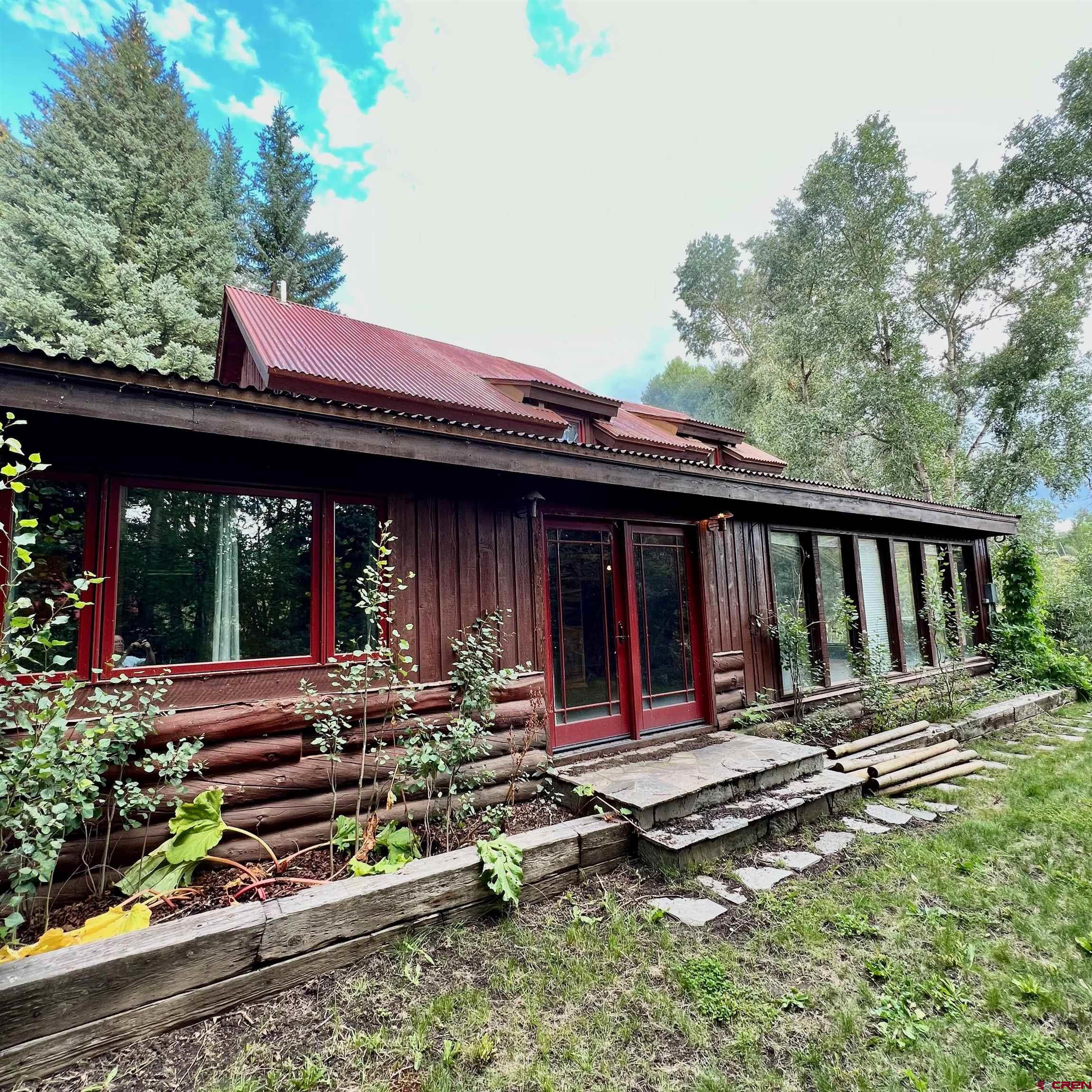 202 Lower Allen Road Crested Butte, CO 81224 - Photo 4 of 21 a view of a house with backyard sitting area and garden