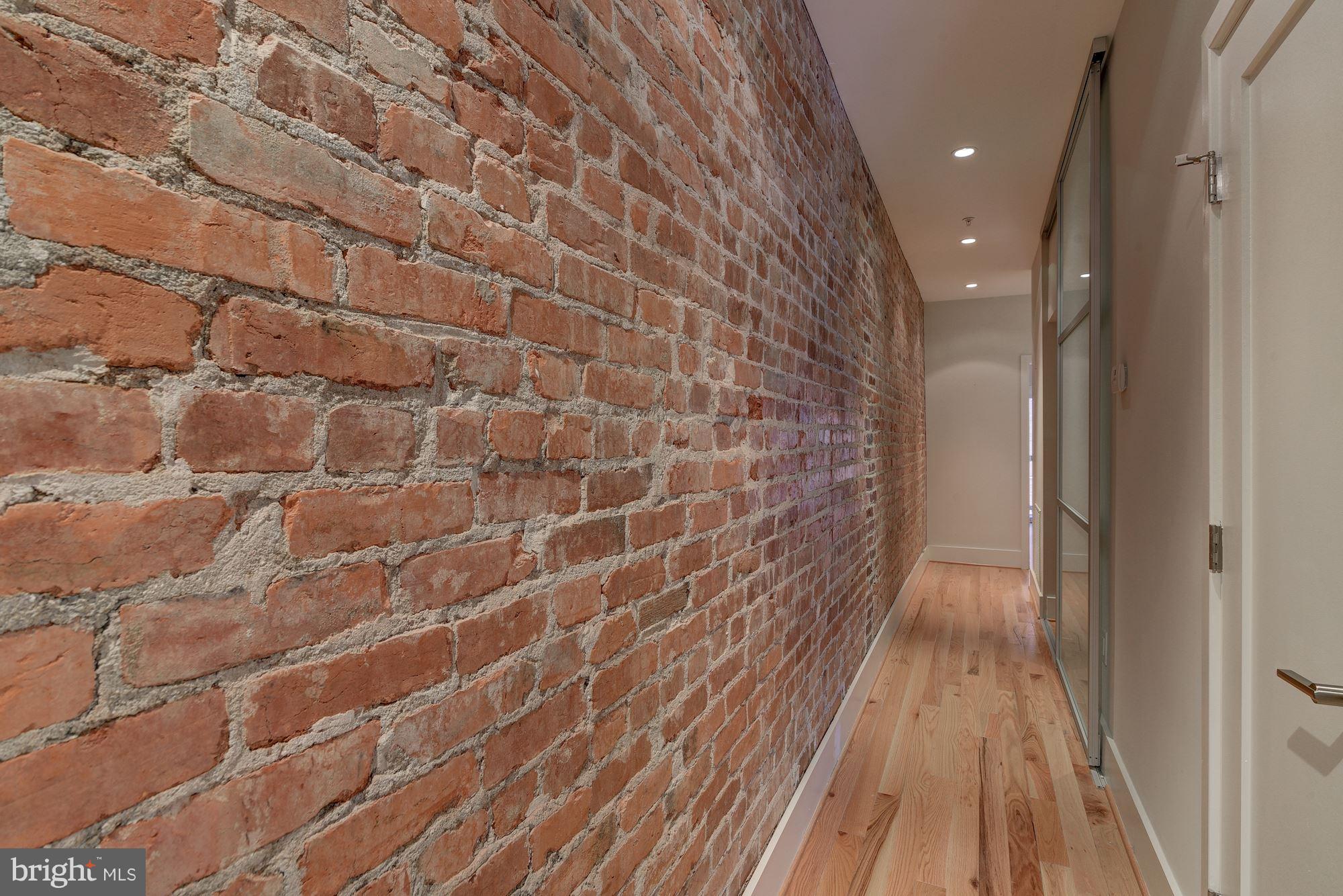 2703 11th Street Northwest, Unit 2 Washington, DC 20001 - Photo 13 of 28 Original brick wall guides you to bedrooms