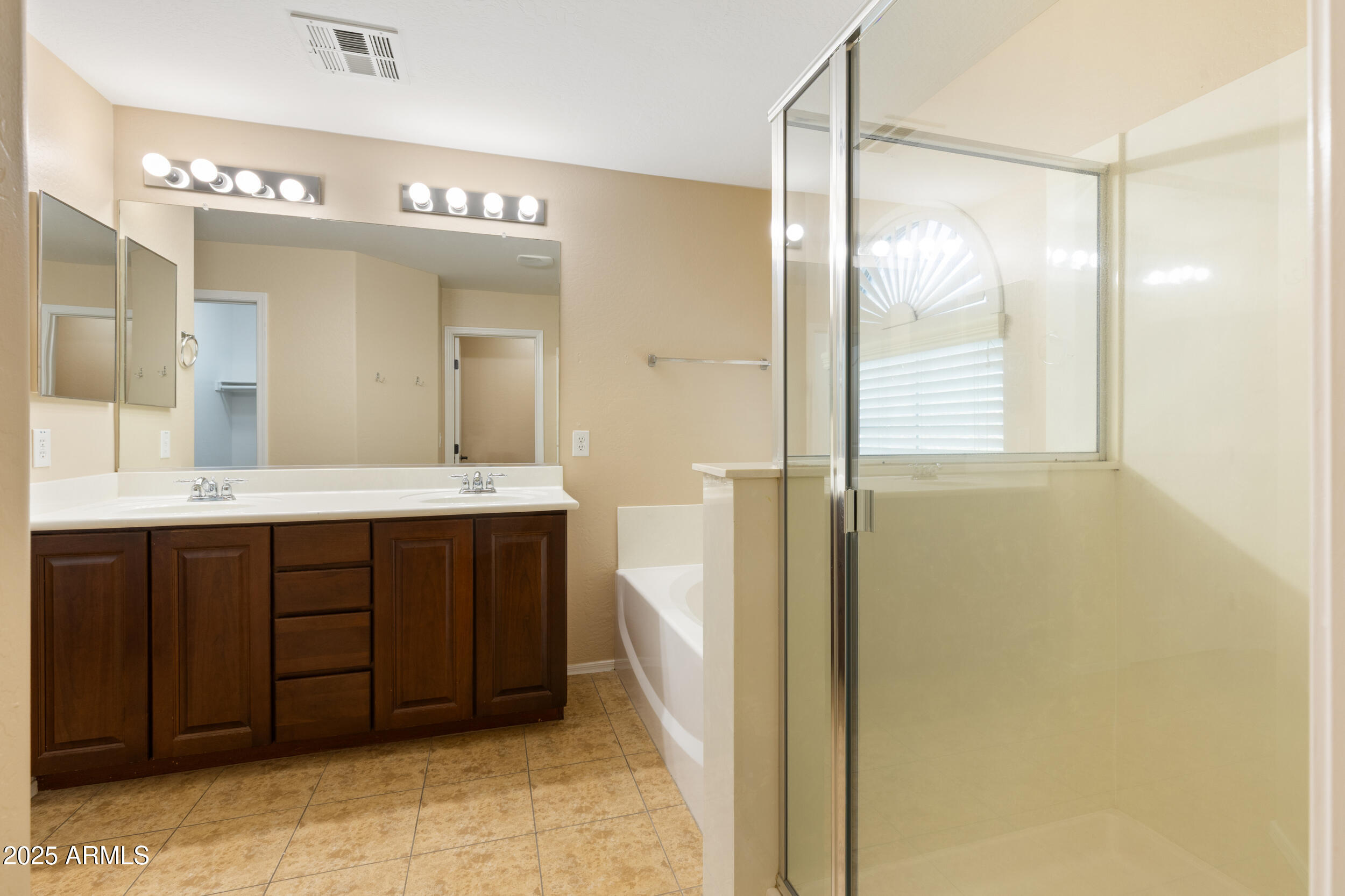 1870 South Colt Drive Gilbert, AZ 85295 - Photo 38 of 42 a bathroom with a double vanity sink a mirror and a shower