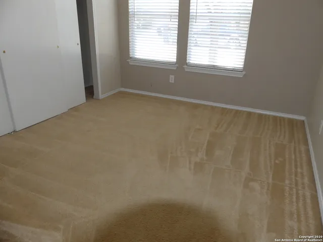 a bathroom with a toilet and a shower curtain