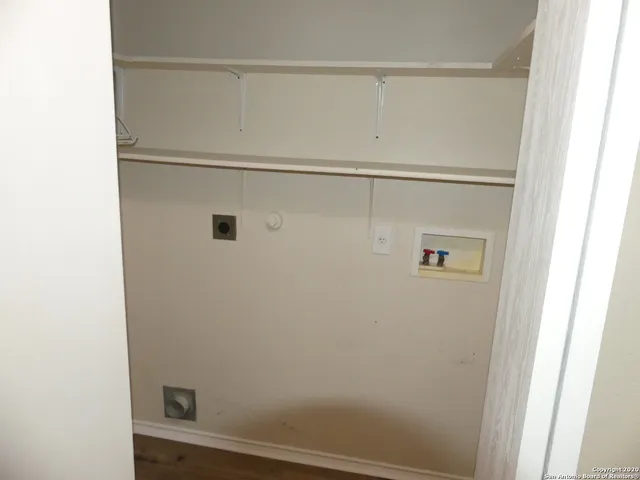 a view of backyard with wooden fence