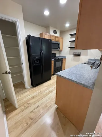 a kitchen with stainless steel appliances granite countertop a sink stove and cabinets