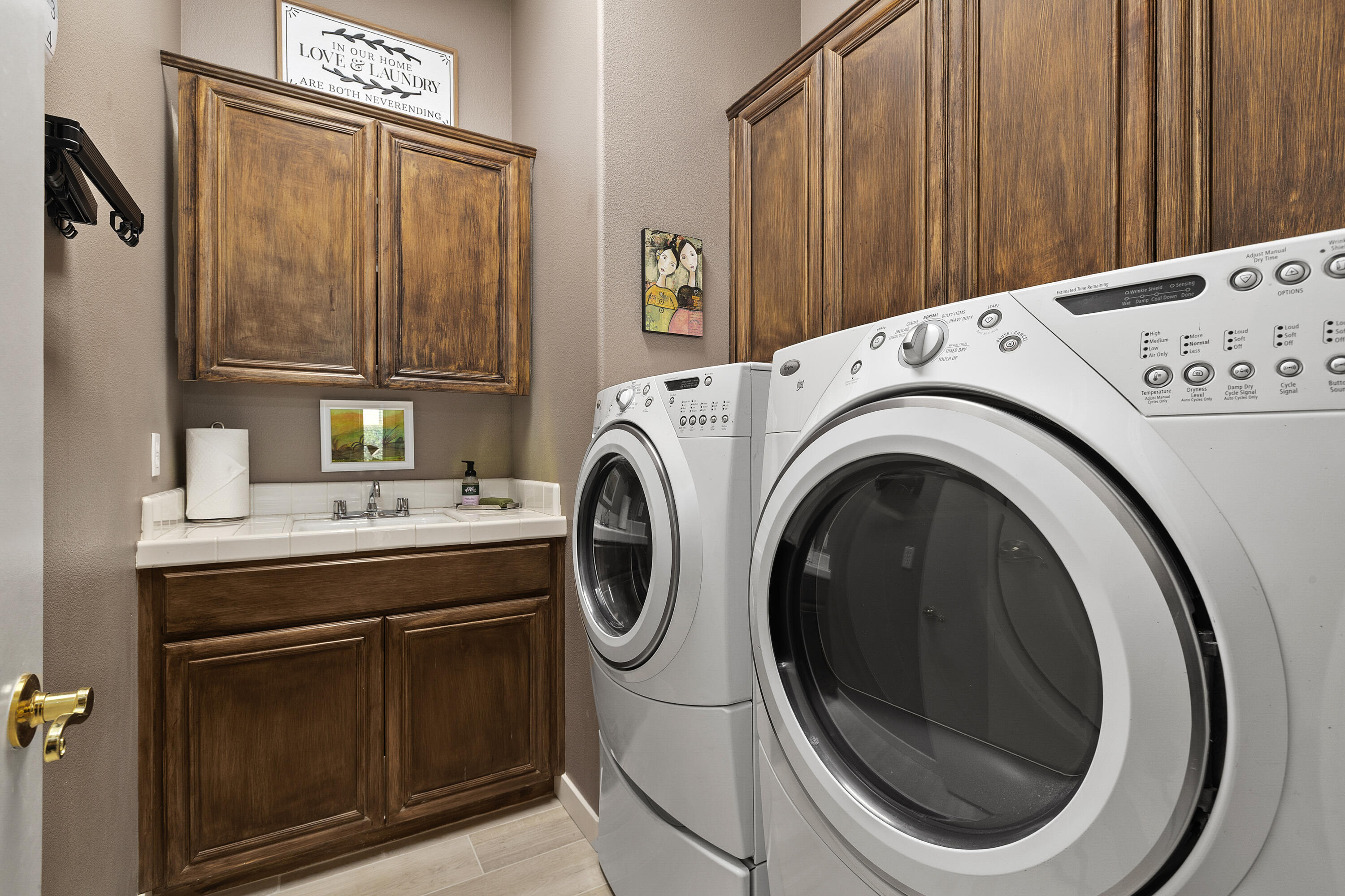 89 North Kavenish Drive Rancho Mirage, CA 92270 - Photo 30 of 40 a utility room with dryer and washer