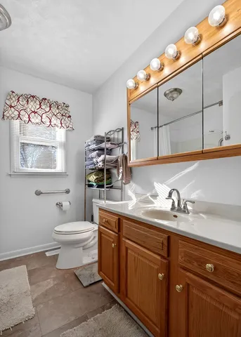 a bathroom with a toilet sink and mirror
