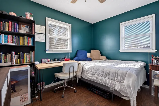 a bedroom with a bed and a bookshelf