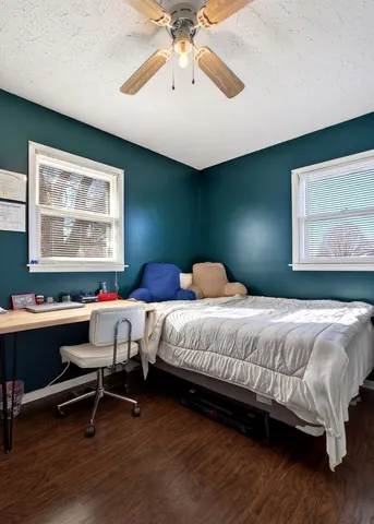 a bedroom with a bed and a large window