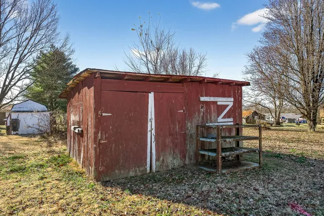 a backyard of a house with table and chairs
