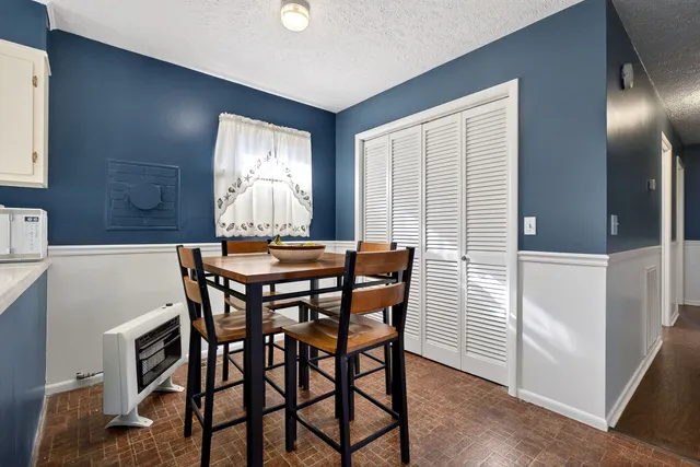 a view of a dining room with furniture and window