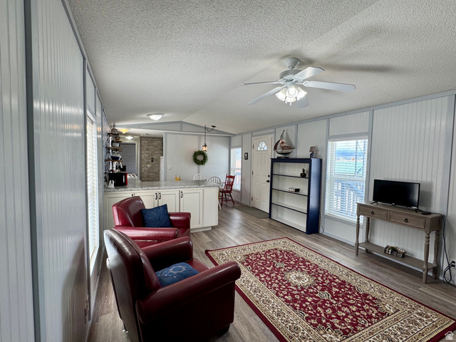 972 Ridgeway Loop, Unit 228 Garden City, UT 84028 - Photo 9 of 26 Living room featuring wood finished floors, plenty of natural light, and ceiling fan