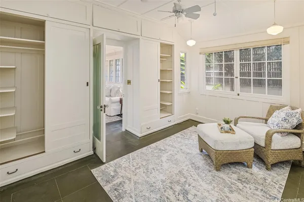 a spacious bedroom with a bed and wooden floor