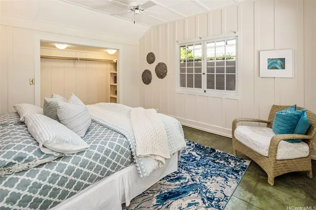 a bedroom with a bed and a couch