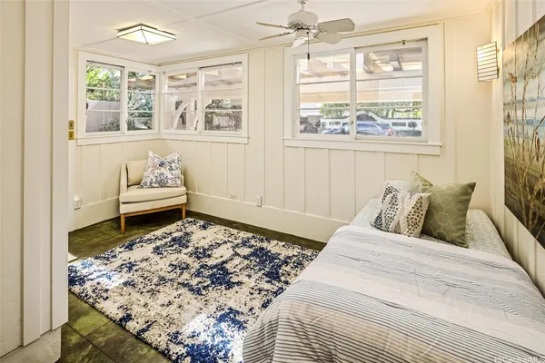 a bed sitting in a bedroom next to a window