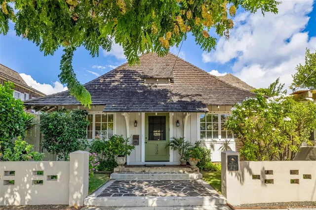 a front view of a house with garden