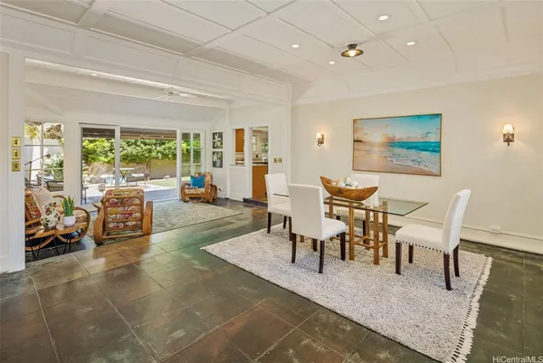 a living room with furniture and large windows