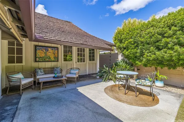 a backyard of a house with outdoor seating