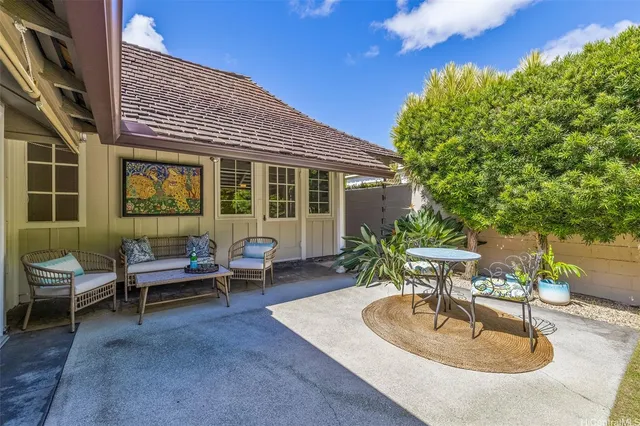 a backyard of a house with outdoor seating