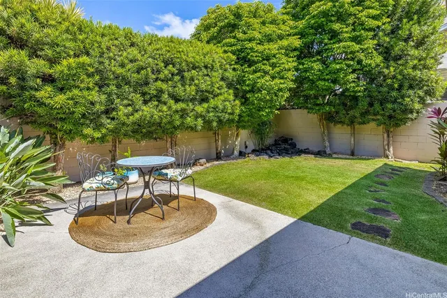 a backyard of a house with fountain and outdoor seating