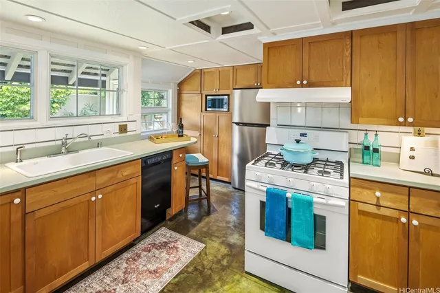 a kitchen with a sink stove and cabinets