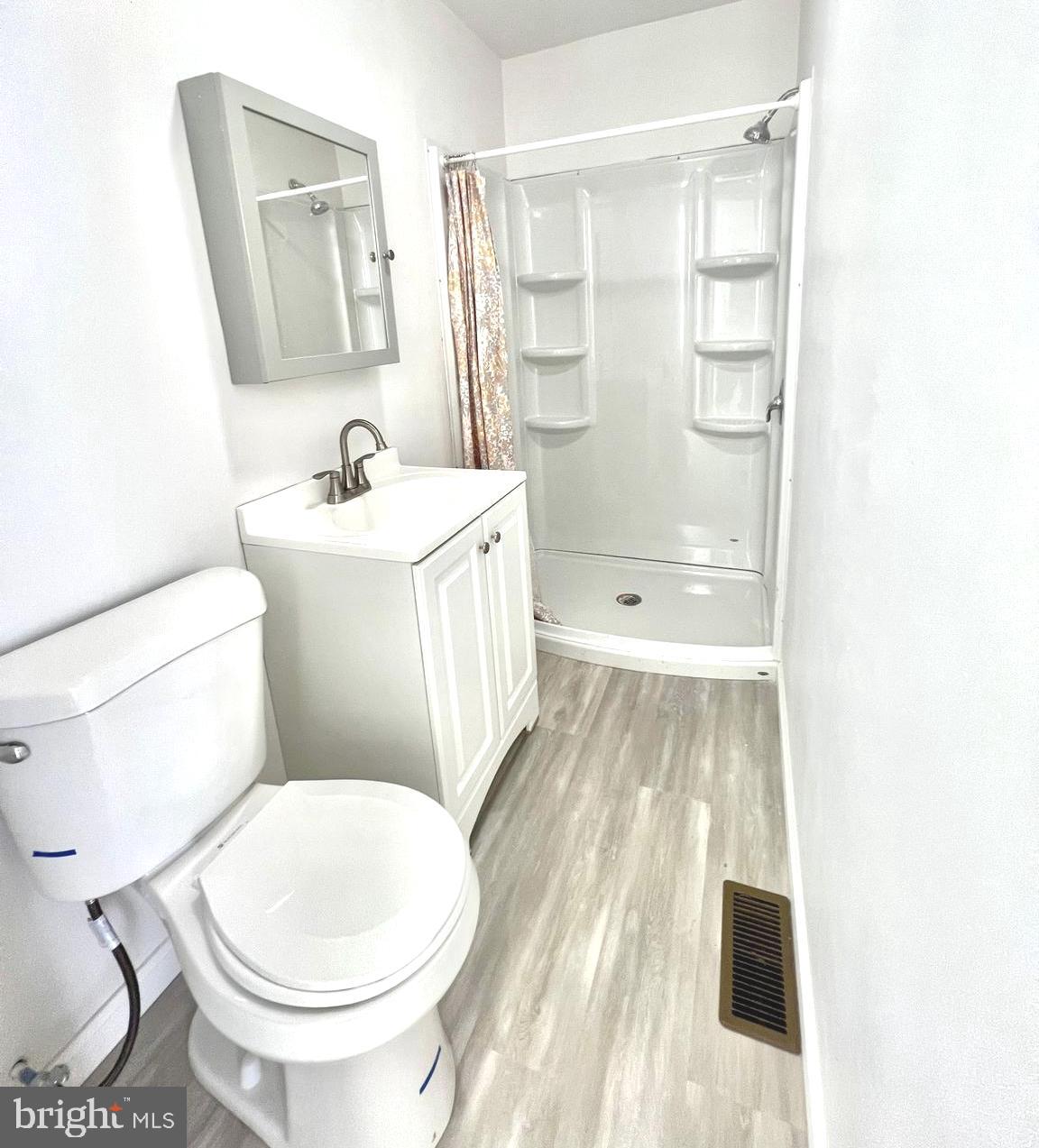 a white toilet sitting next to a bathroom sink