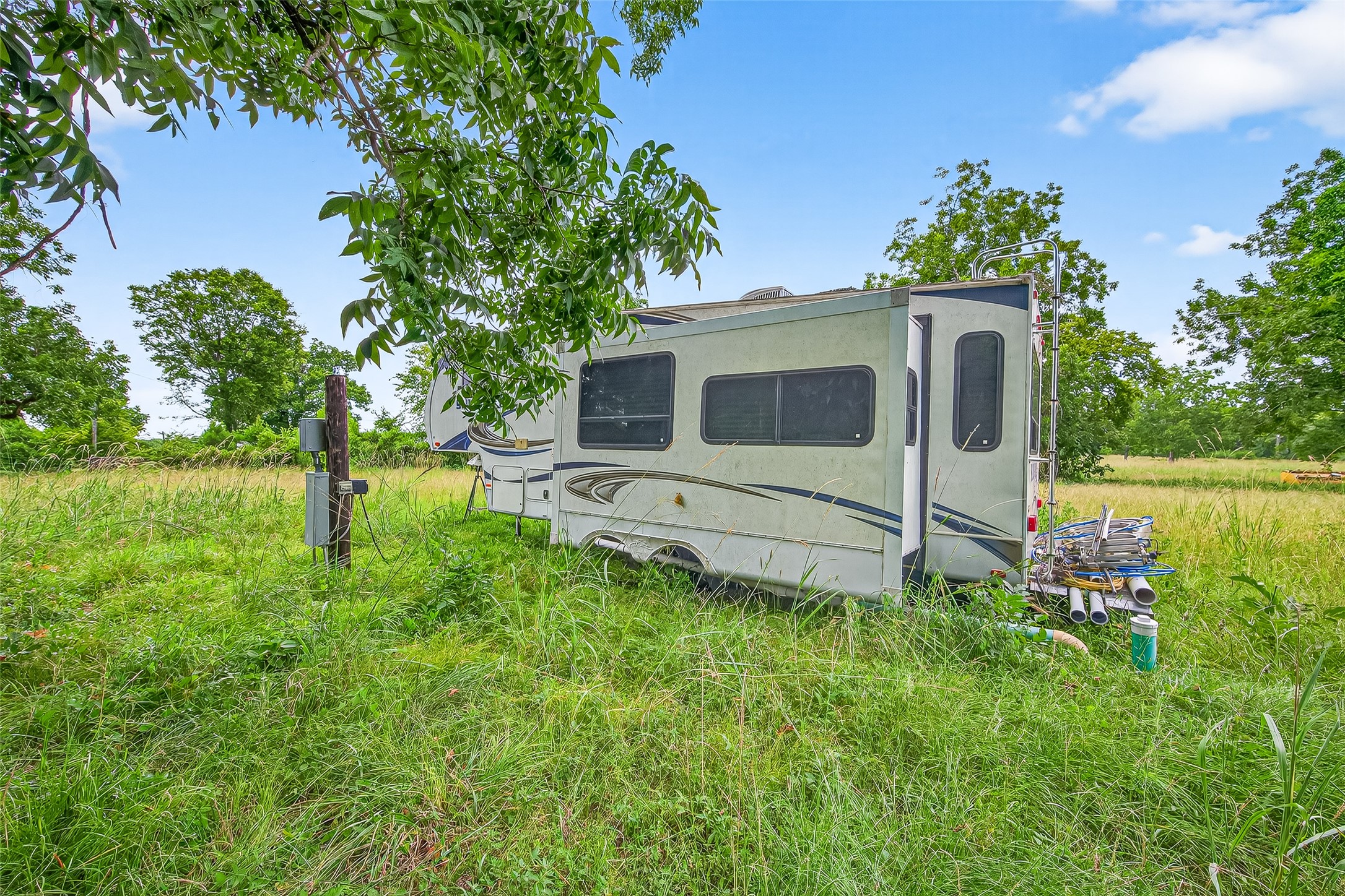 14132 North Old Highway 35 Road Moscow, TX 75960 - Photo 14 of 18 a backyard of a house with table and chairs