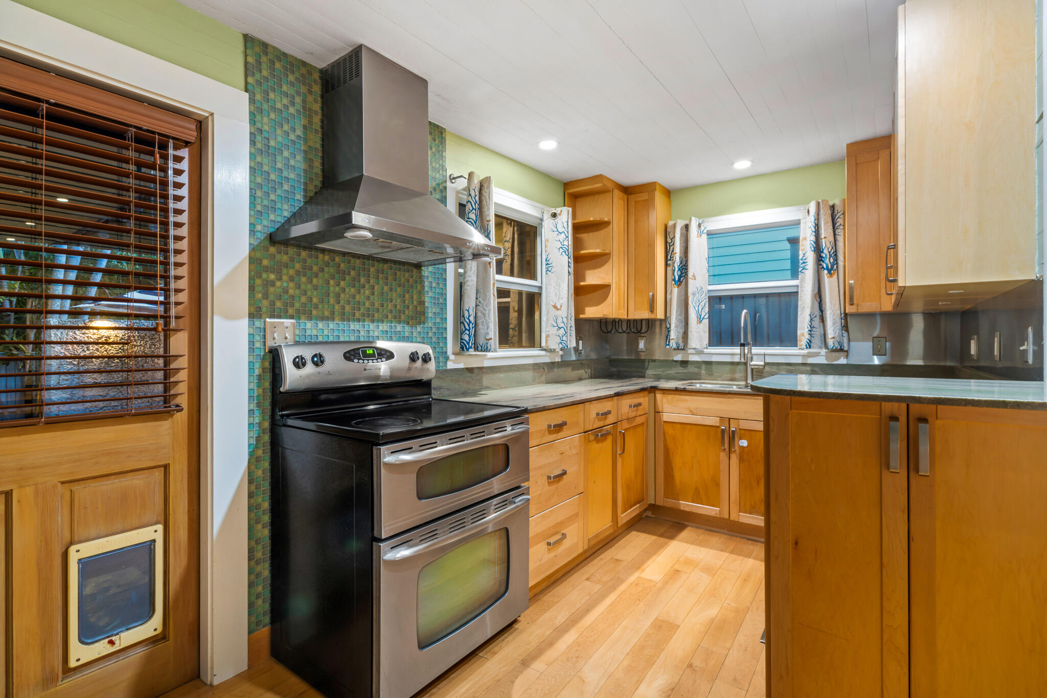 1120 Seminary Street Key West, FL 33040 - Photo 11 of 42 a kitchen with stainless steel appliances granite countertop a stove a sink and a refrigerator