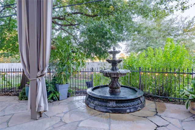 a front view of a house with fountain fountain and outdoor seating