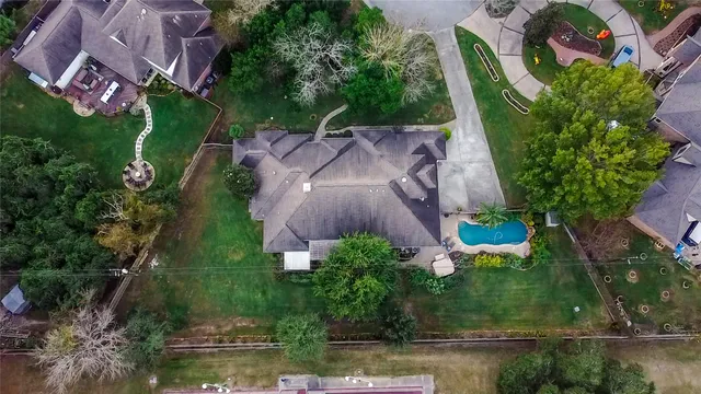 an aerial view of a house with garden space and street view