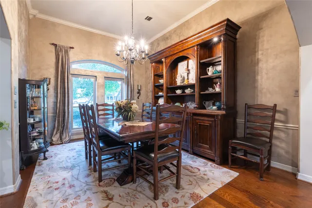 a view of a dining room with furniture and a chandelier