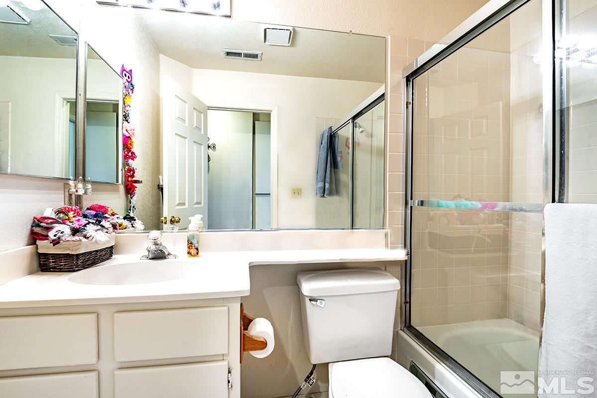 2805 Alpine Creek Road Reno, NV 89519 - Photo 15 of 21 a bathroom with a sink mirror vanity and toilet