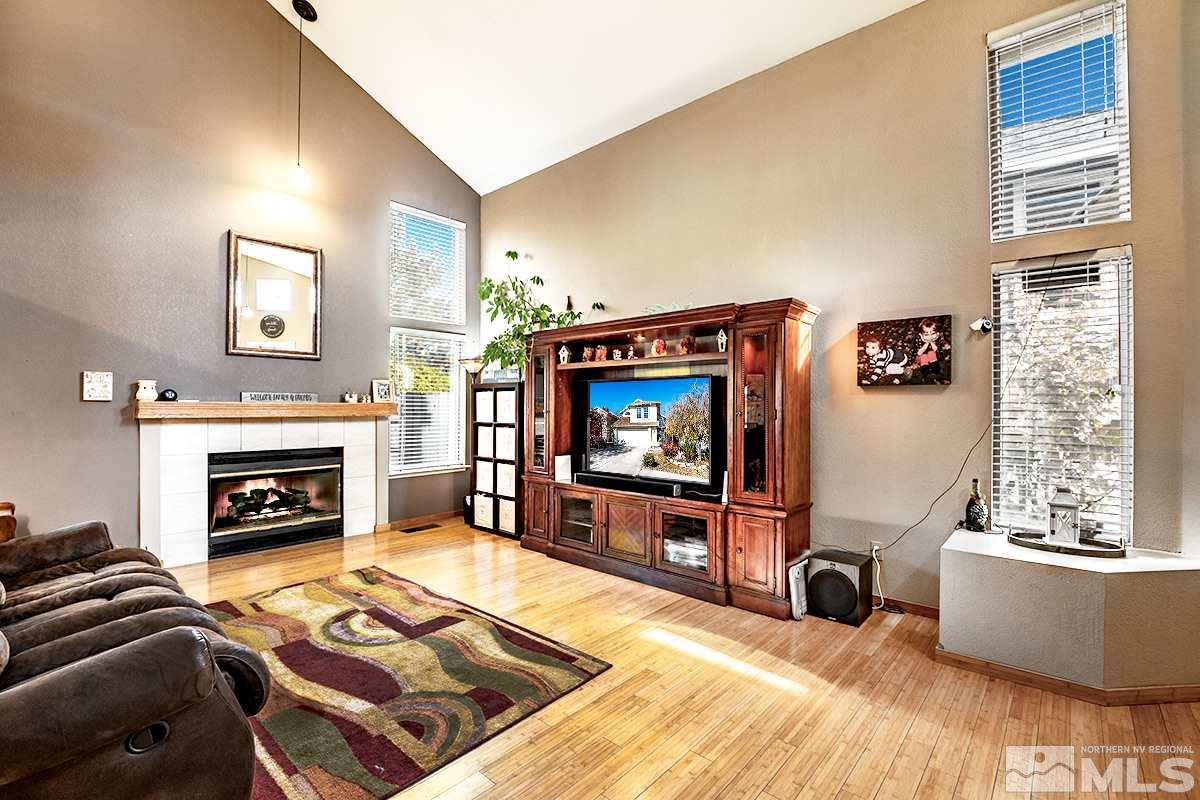 2805 Alpine Creek Road Reno, NV 89519 - Photo 5 of 21 a living room with furniture a flat screen tv and a fireplace