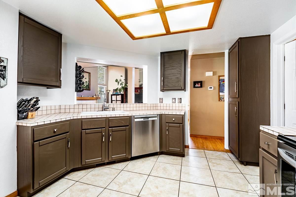 2805 Alpine Creek Road Reno, NV 89519 - Photo 7 of 21 a kitchen with stainless steel appliances granite countertop a refrigerator and a sink