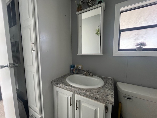 2795 East 28th Road Marseilles, IL 61341 - Photo 22 of 22 a bathroom with a granite countertop sink toilet and a mirror