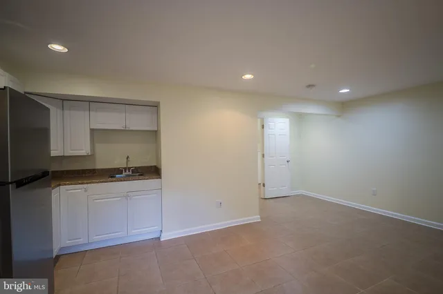 a kitchen with granite countertop a sink and a stove top oven
