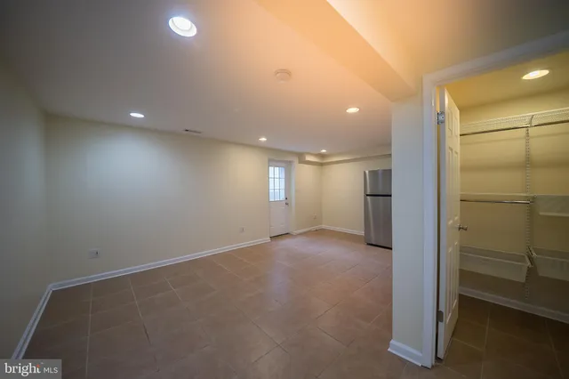 a kitchen with a refrigerator sink and cabinets