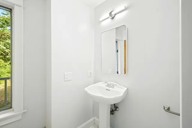 a bathroom with a sink a mirror and a toilet
