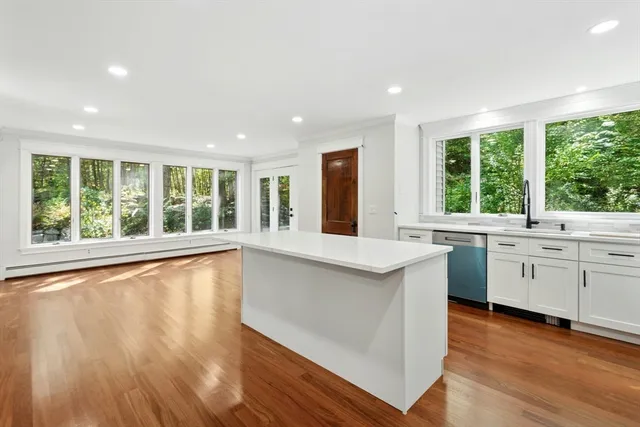 a large white kitchen with a large window
