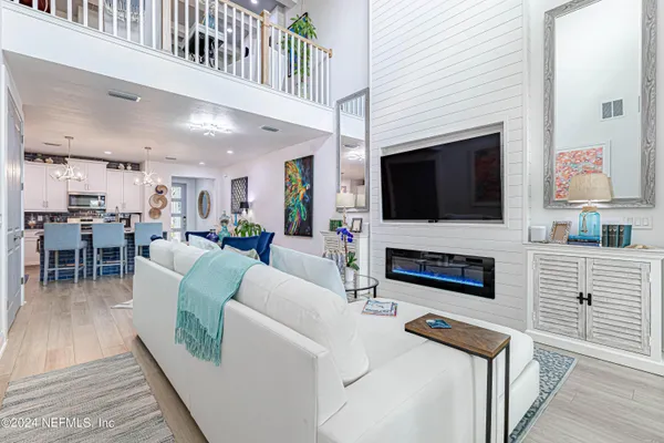 a living room with furniture a flat screen tv and a fireplace