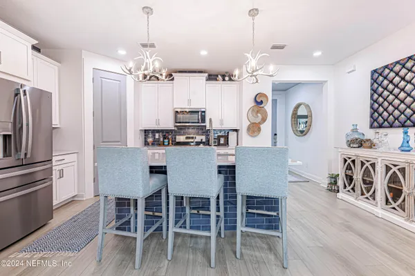 a view of kitchen with microwave and furniture