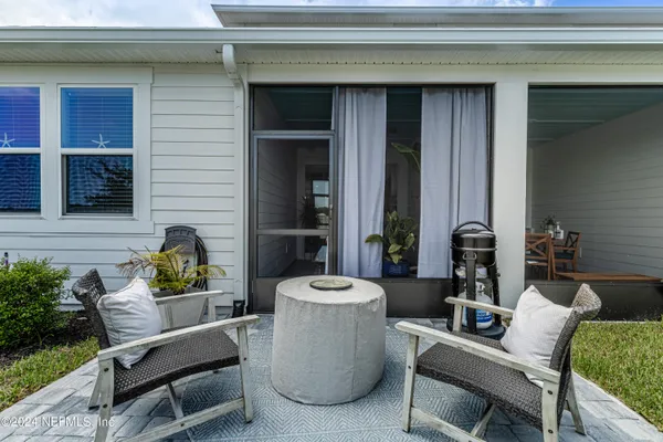 a swimming pool with outdoor seating and yard
