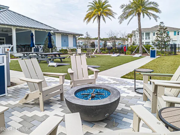 a view of a swimming pool with outdoor seating and plants